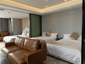 Giường trong phòng chung tại Boman Holiday Apartment Bei Jing lu Jie Deng Du Hui Branch