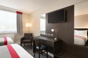 A bed or beds in a room at Ramada Chorley South