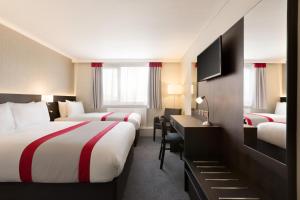 A bed or beds in a room at Ramada Chorley South