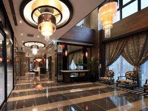 a lobby of a hotel with chandeliers at APA Hotel Shin Osaka Ekiminami in Osaka