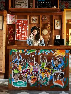 a woman talking on a cell phone behind a counter at Freehand New York in New York