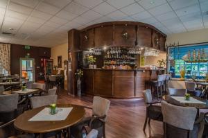 a restaurant with tables and chairs and a bar at Hotel *** NAT Kołobrzeg in Kołobrzeg