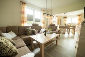 a living room with a couch and a table at Gästehaus Marichen in Aurich