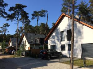 a car parked in front of a house at The Place by Baltic sea in Łukęcin