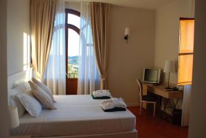 Krevet ili kreveti u jedinici u objektu Saturnia Tuscany Hotel