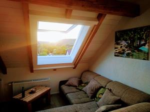 a living room with a couch and a window at Weinblick in Besigheim