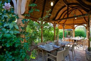 a dining area with tables and chairs in a pavilion at Babiččina Zahrada Penzion & Restaurant in Pruhonice