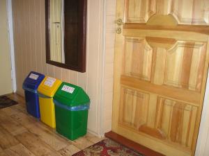 two trash cans sitting next to a door at Pokoje Centrum U Ani in Augustów