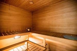 a small wooden sauna with a bench in it at Papli Villa in Pärnu