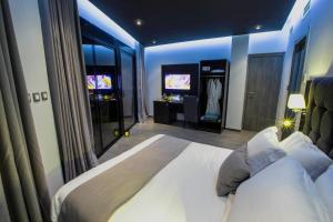 a bedroom with a large bed and a television at Calypso Home Oran in Oran