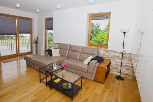 a living room with a couch and a table at Apartament "Park Lotników" in Kraków