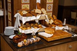 a table topped with lots of different types of bread at Mirotel Resort and Spa in Truskavets