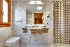 a bathroom with a sink and a toilet at Hotel Casanova in Venice