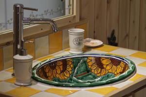 a bathroom sink with a stained glass sink at Tadou-Shack in Tadoussac