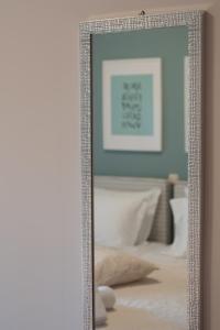 a mirror hanging on a wall in a room at Mary's House in Lefkada Town