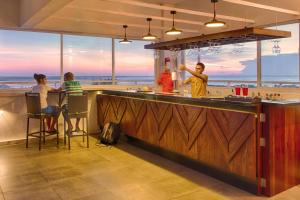 a bar at the beach with people sitting at it at Jetwing Jaffna in Jaffna