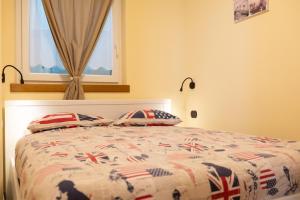 a bedroom with a bed with a british flag bedspread at Pianeta Oro Apartments in Livigno