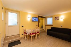 a living room with a table and a couch at Pianeta Oro Apartments in Livigno