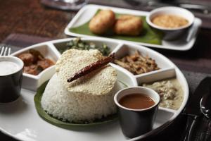 a plate of rice and other food on a table at Jetwing Jaffna in Jaffna