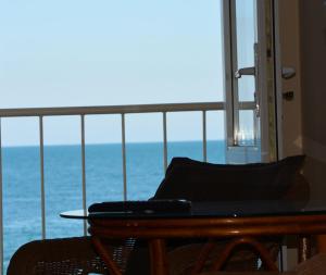 a room with a table and a view of the ocean at Hotel Palma in Odesa