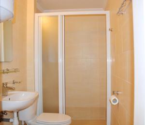 a bathroom with a shower with a toilet and a sink at Hotel Palma in Odesa