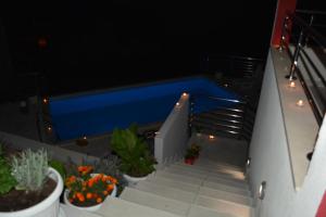 a swimming pool on a balcony with stairs and plants at Luxury Apartments Villa Lenka in Podstrana