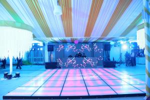 a room with a dance floor with pink lights at Rainforest Resort and Spa, Igatpuri -Nature's Luxury Awaits in Igatpuri