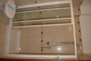 a shower in a bathroom with a window at Hotel Adria in Bari