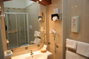 a bathroom with a sink and a mirror at Hotel Adria in Bari