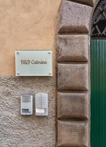 Um sinal num edifício que diz BBC Califórnia em Le Camere di Caterina em Lucca