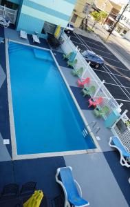 an overhead view of a large swimming pool with lounge chairs at Beachside Resort in Wildwood