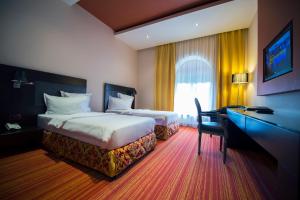 Giường trong phòng chung tại Nane Hotel