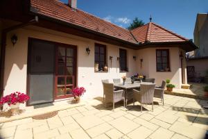 a patio with a table and chairs in front of a house at Leo Vendeghaz in Eger