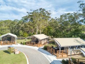 a group of tents in a park with trees at Shoal Bay Holiday Park in Shoal Bay