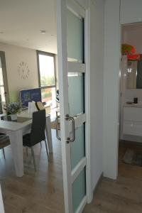 a door leading into a dining room with a table at Appartement plage Salata Rosas in Roses