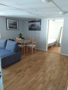 a living room with a couch and a table at Skuteviken Apartments 40 in Bergen