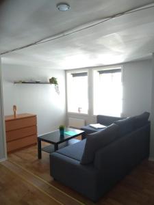 a living room with a couch and a table at Skuteviken Apartments 40 in Bergen