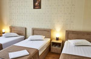 A bed or beds in a room at Hotel Old Borjomi