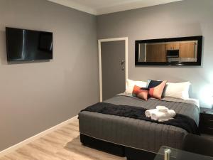 1 dormitorio con 1 cama y TV de pantalla plana en The Mark Studios, en Newcastle