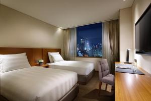 Cama ou camas em um quarto em LOTTE City Hotel Myeongdong