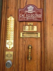 a wooden door with some signs on it at Residence Ca' Foscolo in Venice