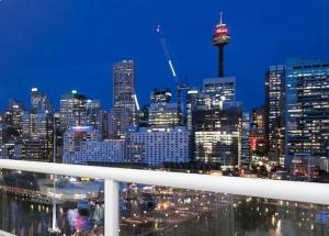 Blick auf die Skyline der Stadt in der Nacht in der Unterkunft Darling Harbour 2 Bedroom Apartment in Sydney