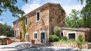 una vecchia casa di mattoni con un muro di pietra di Bastide de l'Endre a Callas