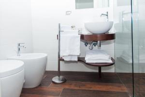 a bathroom with a sink and a toilet at Casa Restino in Torre del Greco