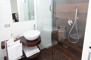 a bathroom with a glass shower and a sink at Casa Restino in Torre del Greco