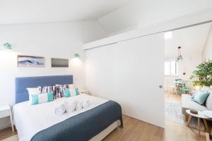 Una cama o camas en una habitación de Feel Nazaré - Boutique Apartments