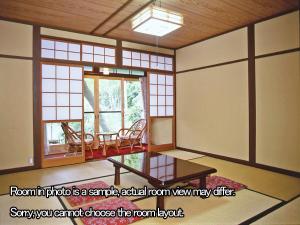 a room with a table and chairs and a window at Kyo no Minshuku Ohara no Sato in Kyoto