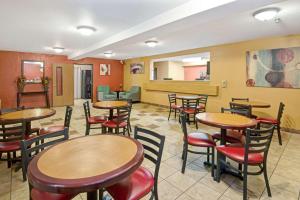 a restaurant with tables and chairs in a room at Super 8 by Wyndham Albuquerque West/Coors Blvd in Albuquerque