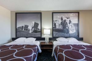 A bed or beds in a room at Super 8 by Wyndham Tucumcari