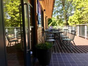 a patio with tables and chairs on a deck at Glen Nevis Youth Hostel in Fort William